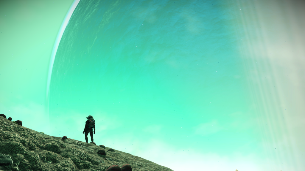 Silhouette of figure standing in front of passive planet in the distance